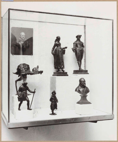 Display case with various objects including small images of human figures and a bust of a man, c. 1959 Canvas Print