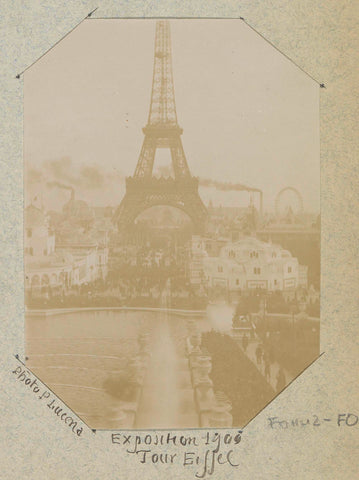 View of the Eiffel Tower during the 1900 World's Fair with chimneys smoking in the background and a Ferris wheel, Paul Lucena, 1900 Canvas Print