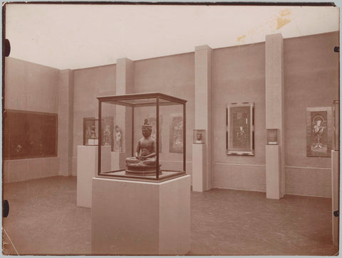 Hall of Asian art including a Buddha statue in a display case, c. 1885 - c. 1940 Canvas Print