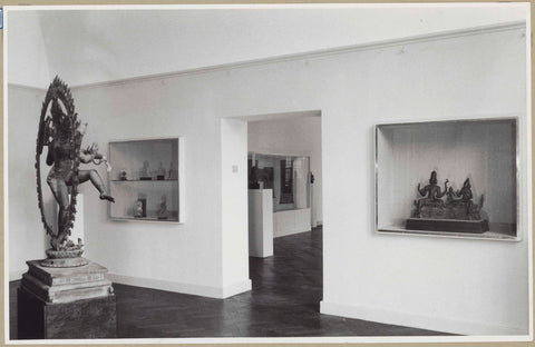 Room with a statue of Shiva Nataraja seen from the side and two wall display cases next to a passage, 1952 Canvas Print