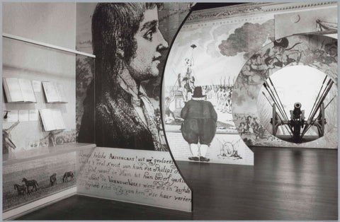 Wall display case with books next to inflated reproductions of engravings, at the back right is a cannon, c. 1991 Canvas Print