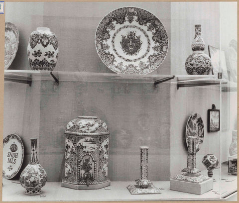 Display case with ceramic objects, including a plate, a pot and two candlesticks, c. 1959 Canvas Print