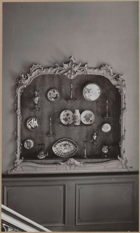 Display case with a decorated frame and candlesticks, dishes and jugs, from the front, c. 1920 - c. 1950 Canvas Print