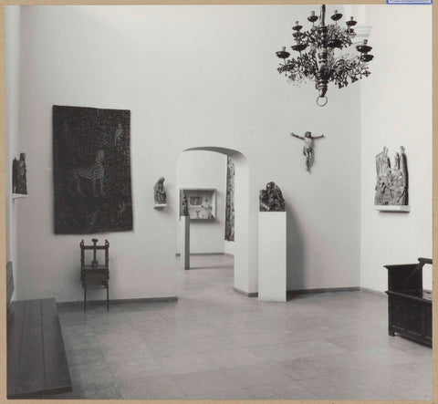 Room with 15th- and 16th century sculptures, partly on pedestals, a tapestry, altar fragments, a candle crown, a printing press and a sitting chest, 1961 Canvas Print