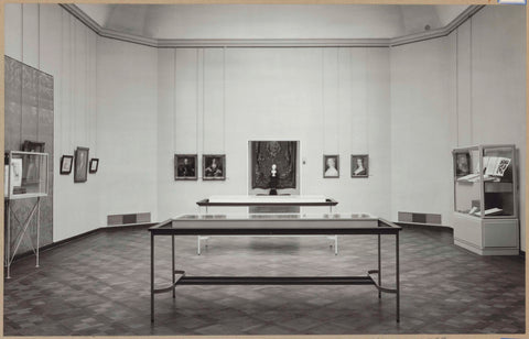 Room with portraits and display cabinets with books, at the back a view to another room, c. 1961 Canvas Print