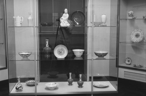 Display case with Chinese porcelain including vases, bowls and a figurin, 1957 Canvas Print