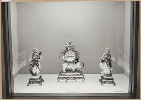 Display case with ceramic objects including a timepiece worn by an elephant, 1962 Canvas Print