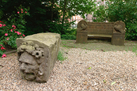 Stone with a face at the front, on the back a garden bench with turkeys on either side, 2003 Canvas Print