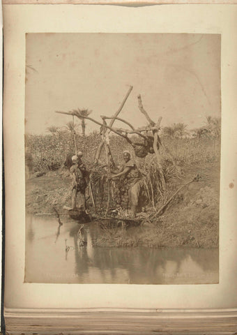 Two men pump water up to irrit the land, G. Lekegian, c. 1880 - c. 1900 Canvas Print