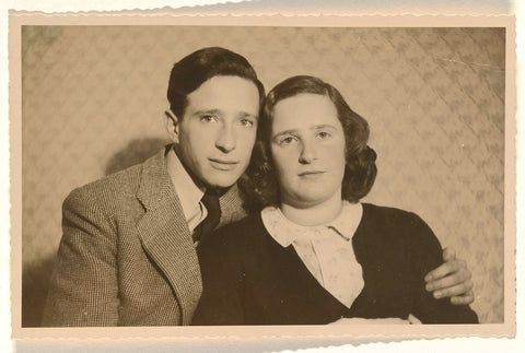 Leo Blumensohn in striped jacket with his arm wrapped around Isabel Wachenheimer, in front of a diamond formation benah, both with serious eyes, 1945, anonymous, 1945 Canvas Print