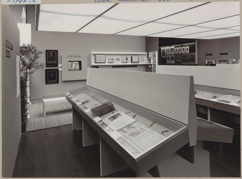 Room with various objects including books in display cases and paintings, c. 1975 Canvas Print