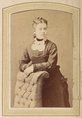 Portrait of a woman in a dress leaning on an armchair, anonymous, c. 1860 - c. 1900 Canvas Print