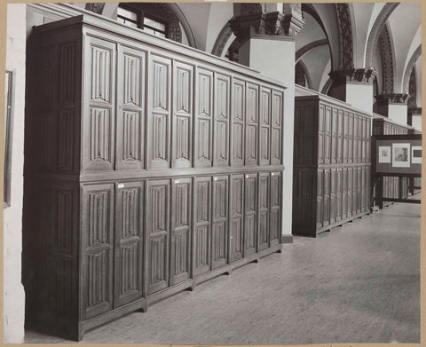 Room with cupboards and at the back right a display case with drawings, c. 1900 - in or before 1938 Canvas Print