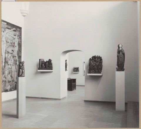 Hall with medieval sculptures on pedestals, a tapestry and a passageway, 1961 Canvas Print