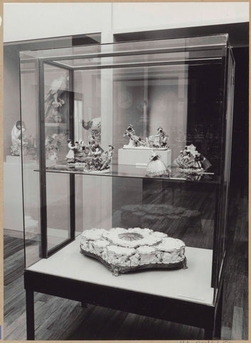 Display case with ceramic objects, in the background a display case with animal figures including a macaw, 1962 Canvas Print