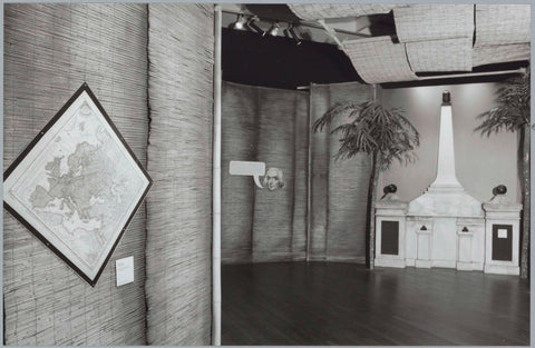 Room with a diamond-shaped map on the left and a monument between two palm trees in the back, c. 1991 Canvas Print