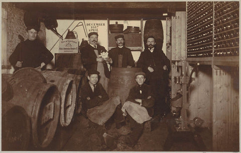 Group portrait of a brewer and servants between barrels and bottles, anonymous, c. 1900 - c. 1910 Canvas Print