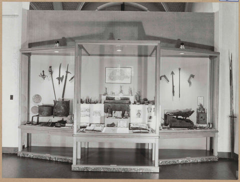 Large display case with various objects including weapons and jugs, 1963 Canvas Print