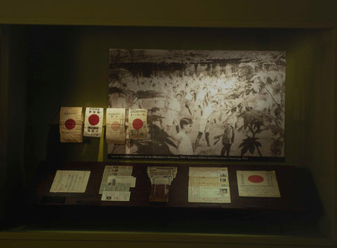 Display case with a photo entitled 'Indian-Dutch children of the folk school in Semarang, 1944' and documents, c. 1999 Canvas Print