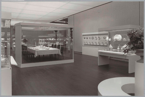 Room with various objects in display cases including a set table and a round bench for visitors with a flower arrangement, c. 1988 Canvas Print