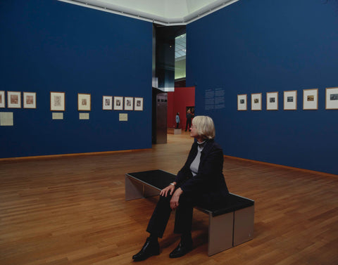 Room with prints and/or drawings and visitor on bench, c. 2003 Canvas Print