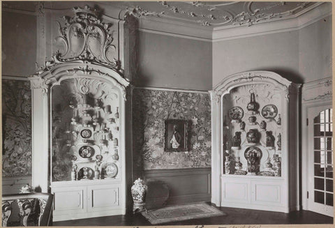 Portrait of a man between two display cabinets with Chinese porcelain, c. 1920 - c. 1950 Canvas Print