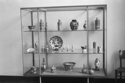 Display case with various objects of Chinese blue-white porcelain including vases, bowls and pots, 1957 Canvas Print