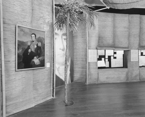 Painting and palm tree next to a ceiling-high reproduction of a portrait of Herman Willem Daendels, c. 1991 Canvas Print