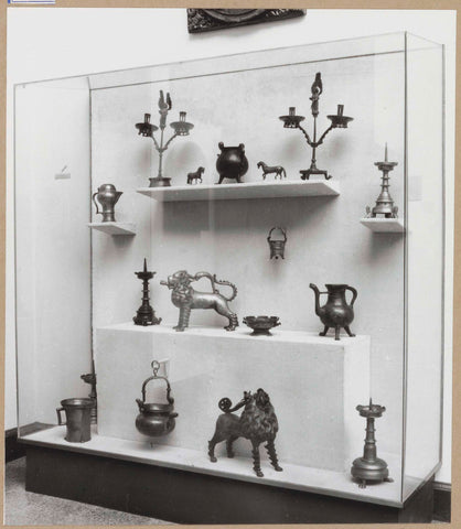 Display case with various objects including candlesticks and two lion figures, c. 1959 Canvas Print