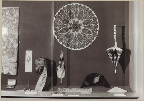 Display case with textile objects including a parasol and a stitch, 1975 Canvas Print