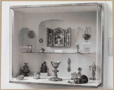 Display case with various objects including a small triptych, a chalice and cups, c. 1959 Canvas Print