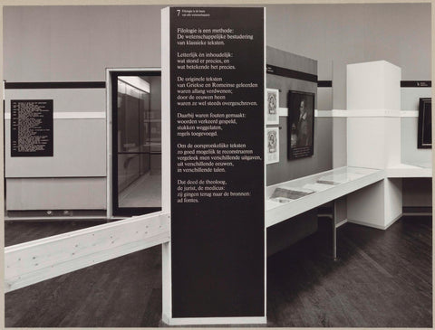 Room with various objects including books in a display case, a painting, an information panel and a door, c. 1975 Canvas Print