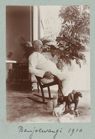 Man in his pajamas in the rocking chair on the veranda surrounded by toy animals., Frits Freerks Fountain Fz. (attributed to), c. 1910 Canvas Print