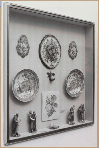 Display case with ceramic objects, including bowls, artificial fruit and small sculptures, c. 1959 Canvas Print