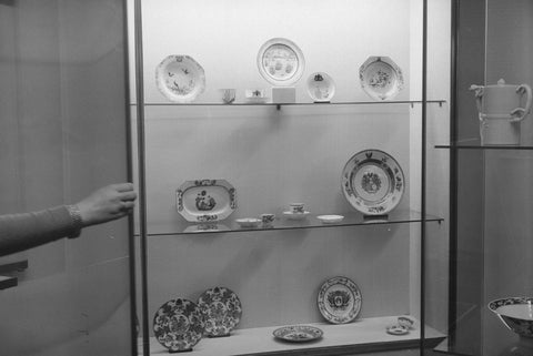 Display case with Chinese weapon porcelain including signs, on the left an arm reaching to the display case, 1957 Canvas Print