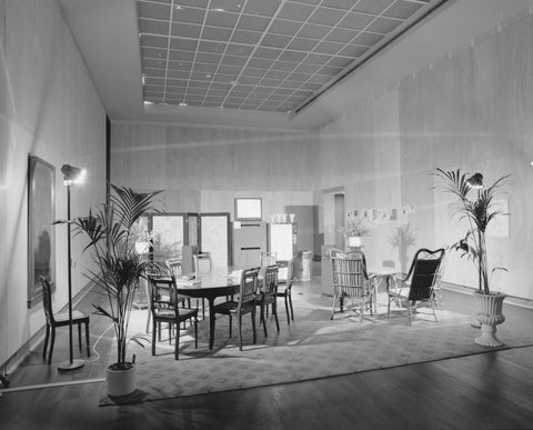 Room with a dining room and a rattan sitting area, in the back of a room screen and a soft drink vending machine, c. 1991 Canvas Print