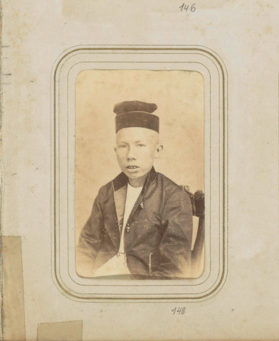 Portrait of a Chinese-Indian young man in a coat with a headgear, W.J. Olland & son, c. 1860 - c. 1890 Canvas Print