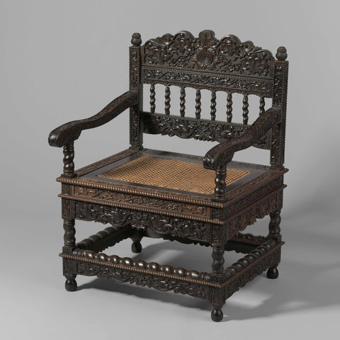 Armchair of tropical wood with a loose seat frame covered with cane, the chair has winding colonettes and is decorated with carved lotus tendrils and rope edges, anonymous, c. 1650 - c. 1699 Canvas Print