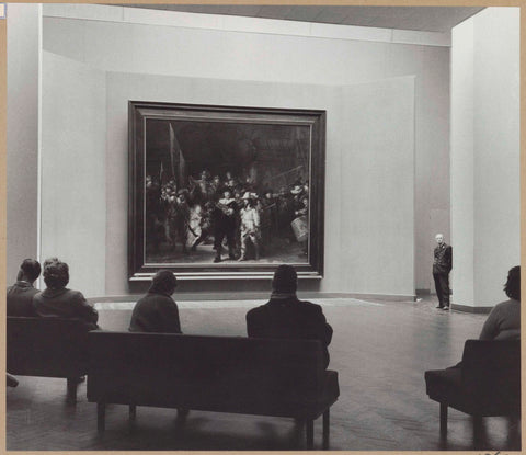 Night watch room with a guard and visitors on benches, seen from behind, 1960 Canvas Print