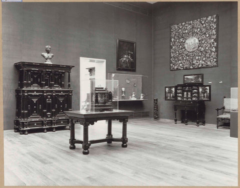 Room with furniture including art cabinets, a table, a bust, a display case with objects of precious metal and a passageway, 1962 Canvas Print