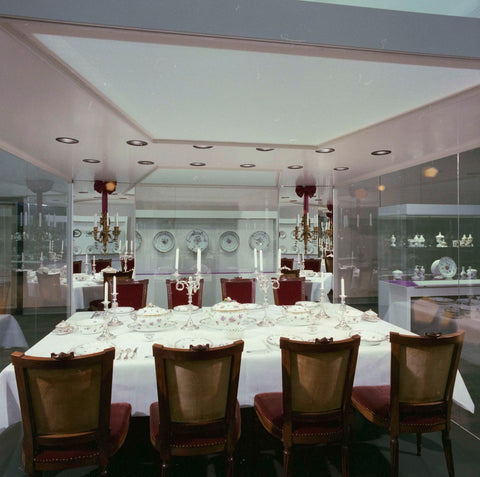 Display case with chairs and a set table with plates, terrines, baskets, cutlery and candlesticks (seen from the long side of the table), c. 1988 Canvas Print