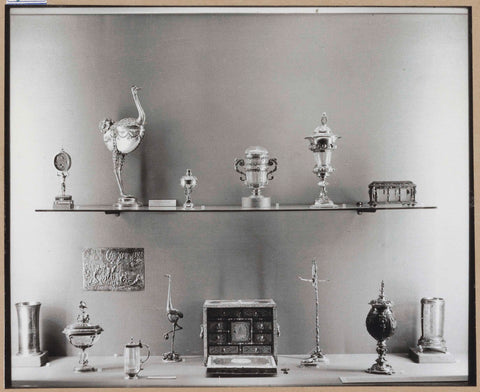 Display case with various metal objects including a box with drawers and two nautilus cups, c. 1959 Canvas Print