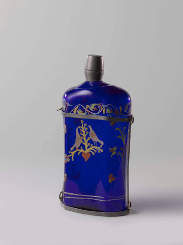 Hexagonal bottle of blue glass with a few turtle doves and the inscription 