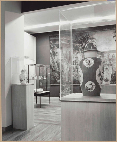 Room with vases on pedestals in display cases and a view of the room with tapestry and display case, 1962 Canvas Print