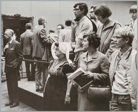 Visitors view the exhibition, in front of a woman in costume, c. 1969 Canvas Print