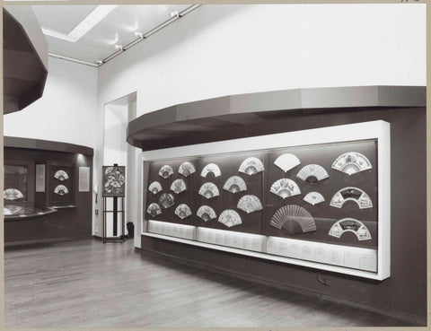 Room with a display case with various fans, on the left of them framed fan sheets and a book with drawings, c. 1992 - c. 1993 Canvas Print