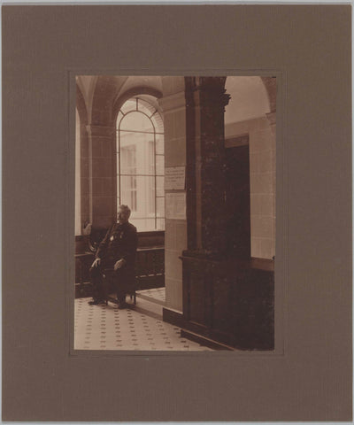 Mr. Ten Hage sitting on a chair in a corner of the building, c. 1920 Canvas Print