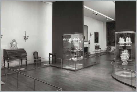 Room with furniture including a secretaire, a timepiece, display cases with ceramics and a passage, c. 1991 Canvas Print