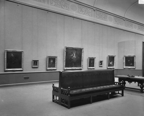 Room with paintings, two benches standing against each other and a table, 1935 Canvas Print