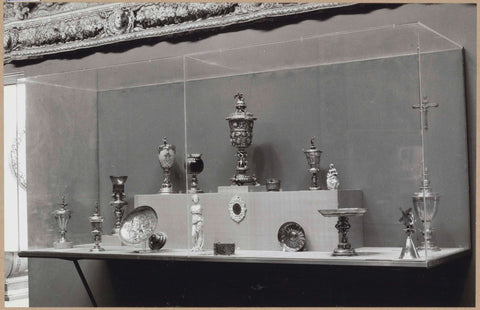 Display case with various objects of metal, including jars, scales, a crucifix and two statues, c. 1959 Canvas Print